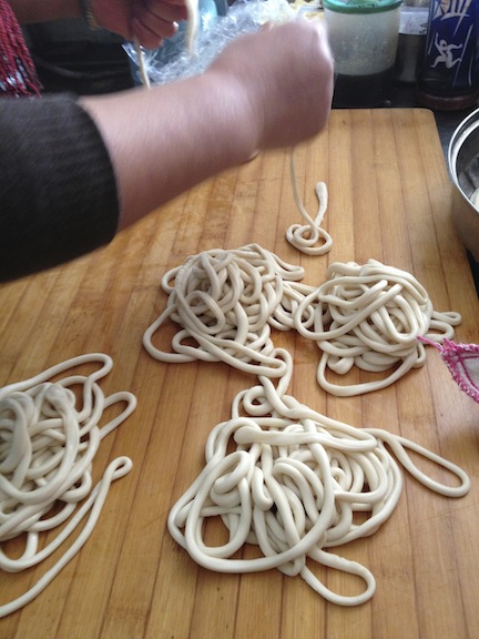 At the restaurant each strand was carefully removed, then stretched a little too make the noodles thinner and longer.